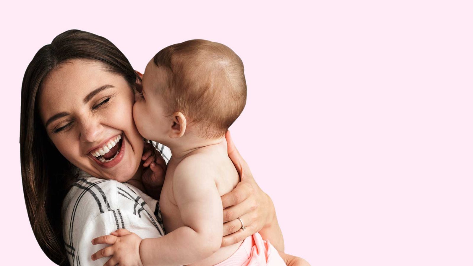A mother laughing as her baby kisses her cheek